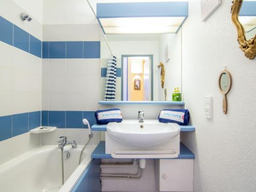 une salle de bain avec un lavabo, une baignoire et un miroir dans l'établissement Apartment Les Marines-3 by Interhome, à La Foux