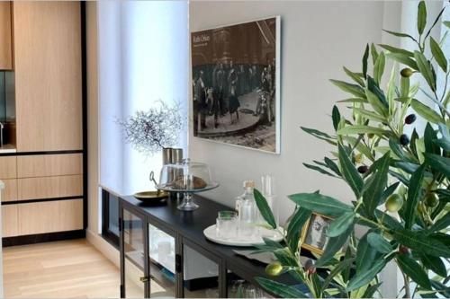 a dining room with a table and a plant at Beaumont Residence in Auckland