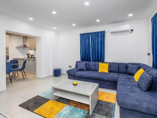 a living room with a blue couch and a table at Apartment Nina by Interhome in Novi Vinodolski