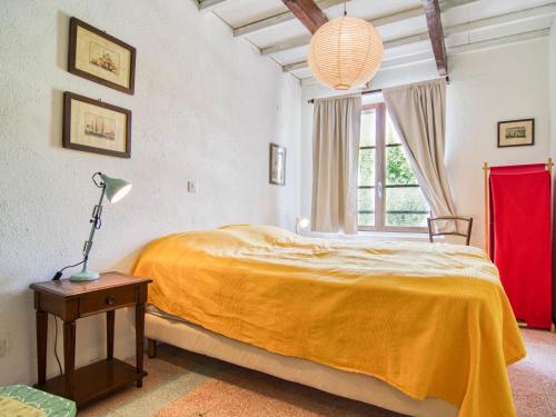 a bedroom with a large bed and a window at Holiday Home Maison de Village Les Ormeaux by Interhome in Tourtour