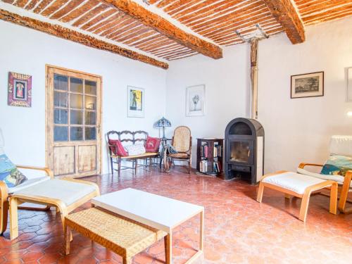 a living room filled with furniture and a fireplace at Holiday Home Maison de Village Les Ormeaux by Interhome in Tourtour