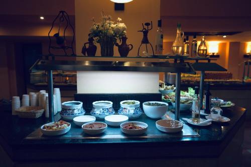 a buffet with bowls of food on a table at Alhambra Thalasso in Hammamet