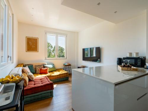 a kitchen and a living room with a couch at Apartment Citrus Garden by Interhome in Cisano sul Neva