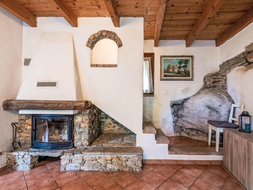 a living room with a stone fireplace in a house at Holiday Home La casa del Fiume by Interhome in Rialto