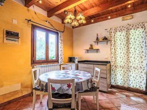 a kitchen with a table and chairs in a room at Holiday Home La casa del Fiume by Interhome in Rialto