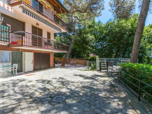 a patio in front of a house with a tree at Apartment La Chicca by Interhome in Castiglioncello