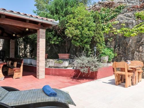 a patio with a table and chairs and trees at Holiday Home Nika by Interhome in Kršan