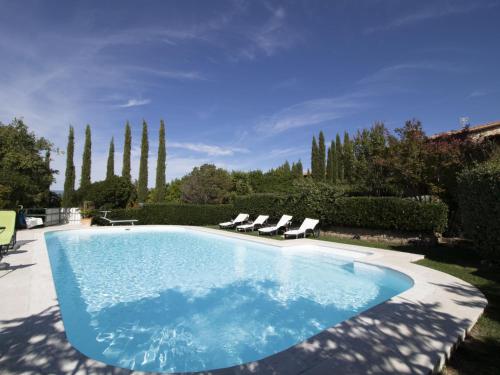 a swimming pool with two lounge chairs at Villa La Gattaiola Piccola by Interhome in Montemerano