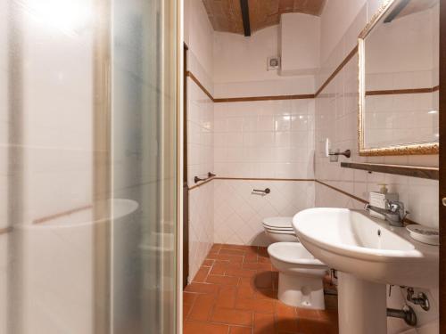 a bathroom with a sink and a toilet and a shower at Villa La Gattaiola Piccola by Interhome in Montemerano
