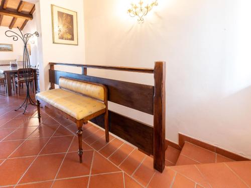 a bench in a room with a dining room at Villa La Gattaiola Piccola by Interhome in Montemerano