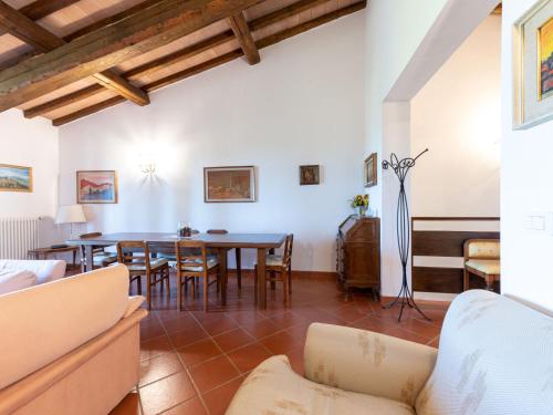 a living room with a table and chairs at Villa La Gattaiola Piccola by Interhome in Montemerano