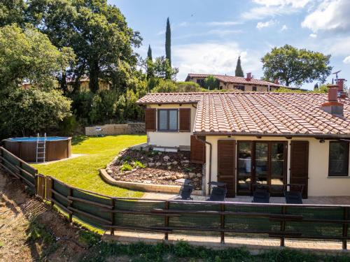 a house with a fence in front of it at Holiday Home La terrazza sulla Maremma by Interhome in Scansano