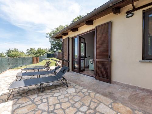 a group of chairs sitting on a patio at Holiday Home La terrazza sulla Maremma by Interhome in Scansano