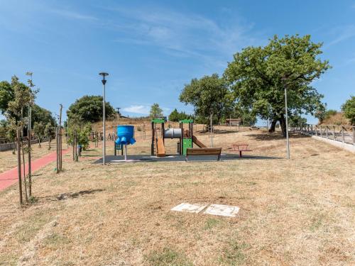 an empty park with a playground with a bench at Holiday Home La terrazza sulla Maremma by Interhome in Scansano