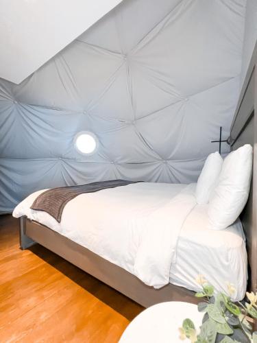 a bedroom with a large white bed in a tent at The Domes Jarabacoa in Jarabacoa