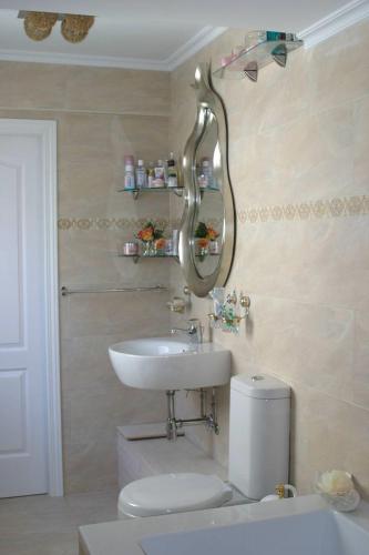 a bathroom with a sink and a toilet and a mirror at Room Centro shared bathroom Wifi in Santander