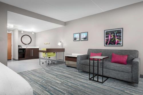 a hotel room with a couch and a desk at Hampton Inn & Suites Atlanta-Six Flags in Lithia Springs
