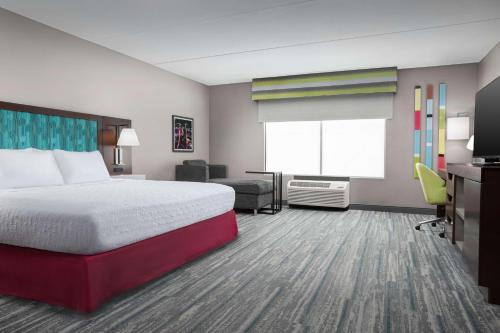 a hotel room with a bed and a window at Hampton Inn & Suites Atlanta-Six Flags in Lithia Springs