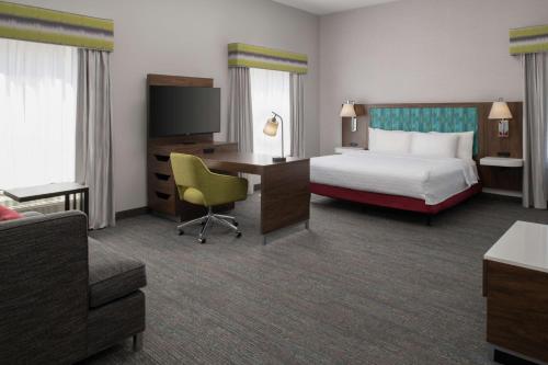 a hotel room with a bed and a desk at Hampton Inn and Suites Seattle - Airport / 28th Avenue in SeaTac