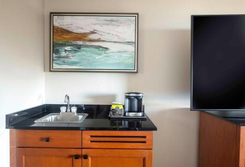 a hotel room with a sink and a tv at Hilton St. Petersburg Carillon Park in St Petersburg
