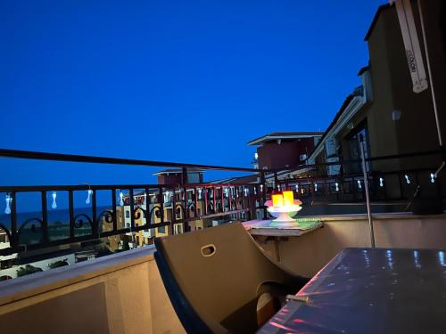 a balcony with a table and a lamp on it at Аpartments Comfort -Marina Cape in Aheloy