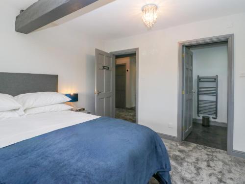 a bedroom with a large bed and a chandelier at Fell View House in Kendal