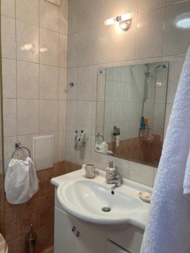 a bathroom with a sink and a mirror at Аpartments Comfort -Marina Cape in Aheloy