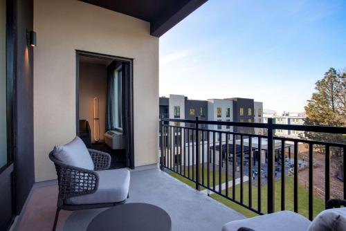 a balcony with a chair and a view of a city at Homewood Suites By Hilton Missoula in Missoula