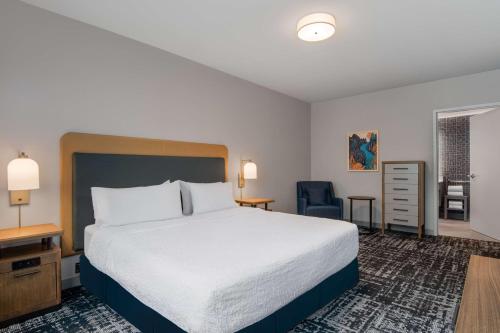 a hotel room with a bed and a chair at Homewood Suites By Hilton Missoula in Missoula