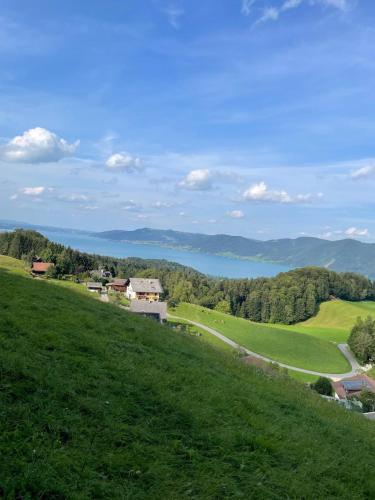 a view of a golf course on a hill at Gästehaus Jedinger in Sankt Georgen im Attergau