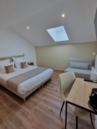 a bedroom with a bed and a table and a couch at domaine de saint jacques devant bruyères in Vienville