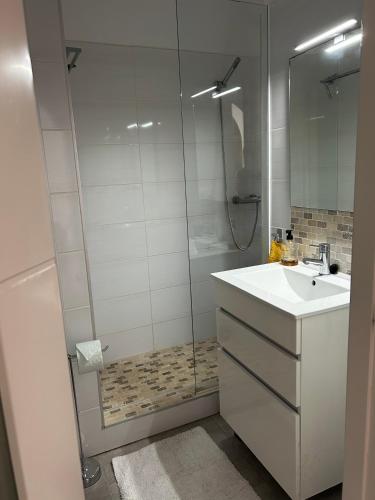 a bathroom with a shower and a sink and a mirror at Tranquil setting in Moraira