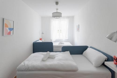 a room with a couch and a bed with a window at Studio Bauhaus am Hauptbahnhof in Dessau