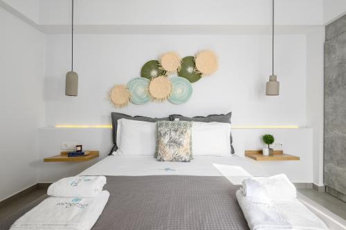 a bedroom with a white bed with two pillows at Margaret of Naxos in Agios Prokopios