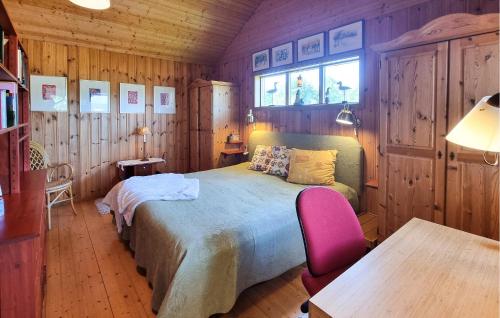 a bedroom with a bed and a table and a window at 4 Bedroom Lovely Home In Fagerfjäll in Djupvik