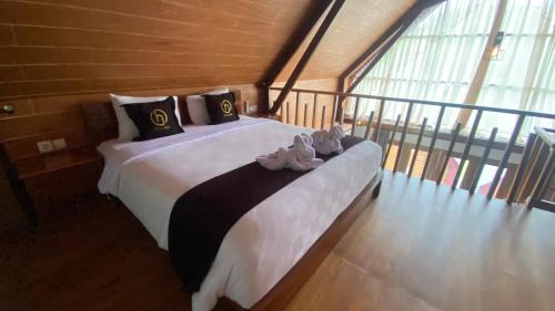 a bedroom with a large bed with shoes on it at Drini Hills Diamond Villa in Brono