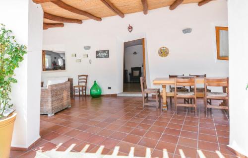 a large living room with a table and chairs at Nice Home In Orgosolo With Wifi in Orgosolo