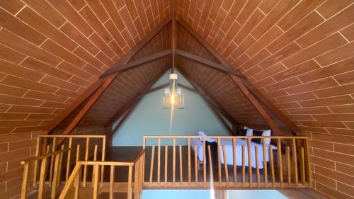 a room with a wooden ceiling and a chandelier at Drini Hills Diamond Villa in Brono