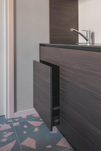 a kitchen with a sink and a counter at Resume apartments in Kaunas