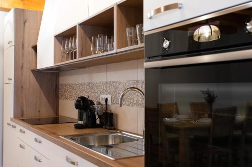 a kitchen with a sink and a microwave at Wellba Homestead Planina in Ajdovščina