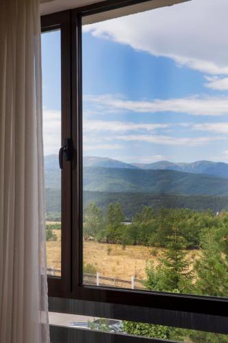 a window with a view of a mountain view at Aspen studio Mountain retreat at Aspen Resort Golf Ski & Spa in Razlog