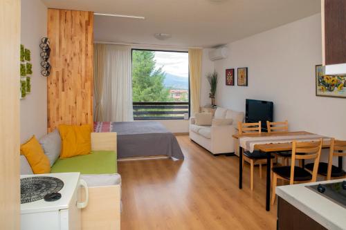 a living room with a bed and a dining room at Aspen studio Mountain retreat at Aspen Resort Golf Ski & Spa in Razlog