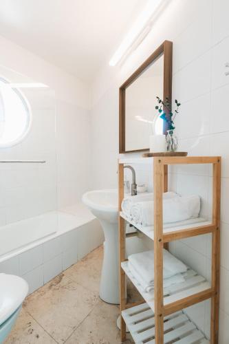 a bathroom with a mirror and a sink at David Frishman Residence - Sea view penthouse in Tel Aviv