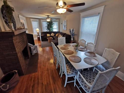 a dining room with a table and chairs and a fireplace at Prime location! 4 bedroom house located right next to the casino and the falls in Niagara Falls