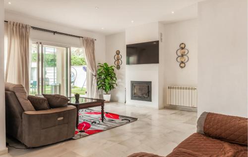 a living room with a couch and a table at Beautiful Home In Bollullos De La Mitaci in Bollullos de la Mitación