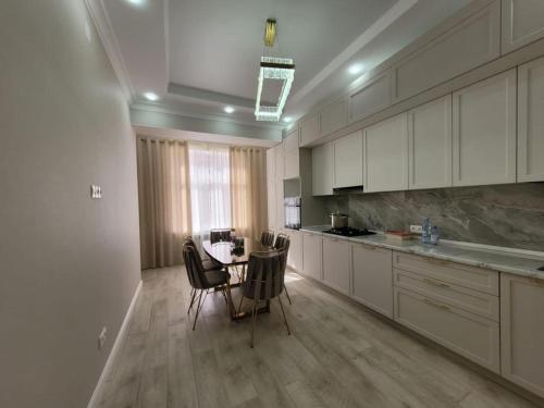 a kitchen with a table and chairs in it at квартира in Aktau