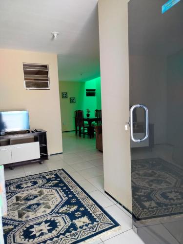 an open door to a living room with a table at Casa Ubajara in Ubajara