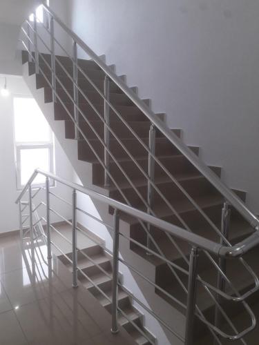 a metal spiral staircase in a white room at Apartmani Previja in Berane