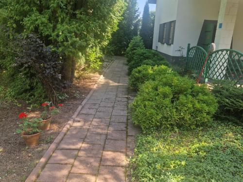 a brick path in a garden next to a house at Orion in Mąchocice