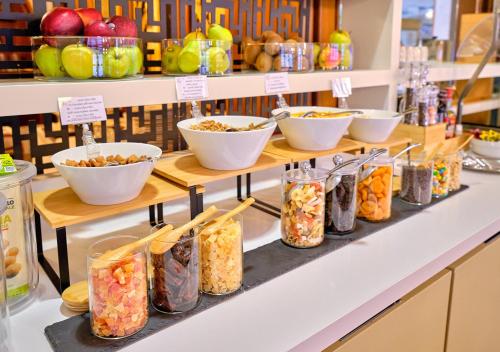 a display shelf with bowls of food on it at Hotel Eden Garda in Garda
